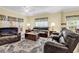 Cozy living room with plush leather sofas, area rug, and lots of natural light at 447 Mahogany Dr. # 102, Murrells Inlet, SC 29576