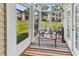 Bright sunroom with large windows, cushioned seating, and colorful rug at 447 Mahogany Dr. # 102, Murrells Inlet, SC 29576