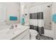 Bright bathroom featuring a shower-tub combination with a stylish striped shower curtain and coordinated blue towels at 4518 N Plantation Dr. # G-5, Little River, SC 29566