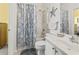 Clean bathroom featuring a shower/tub combo with a seashell-themed curtain and white vanity at 4518 N Plantation Dr. # G-5, Little River, SC 29566