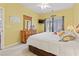Sunny bedroom featuring a queen-sized bed, wooden dresser, and bright yellow walls at 4518 N Plantation Dr. # G-5, Little River, SC 29566