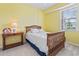 Cozy bedroom showcasing a twin-sized bed, side table, and a sunny window at 4518 N Plantation Dr. # G-5, Little River, SC 29566