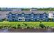 Exterior view of Unit G5, a well-maintained building on a lush lawn near a body of water at 4518 N Plantation Dr. # G-5, Little River, SC 29566