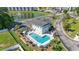 Aerial view of a community pool featuring a hot tub, lounge chairs, picnic tables, and well-manicured landscaping at 4518 N Plantation Dr. # G-5, Little River, SC 29566