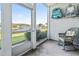 Relaxing screened porch with a view of the waterway, featuring a wicker rocking chair and beach chairs at 4518 N Plantation Dr. # G-5, Little River, SC 29566