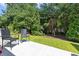 Peaceful backyard with green grass, chairs and mature landscaping offers a peaceful and private setting at 468 Papyrus Circle # 468, Little River, SC 29566