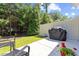 Private backyard featuring green grass, a black grill, potted plants and a privacy fence at 468 Papyrus Circle # 468, Little River, SC 29566