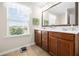 Bathroom with double sink vanity, framed mirror, and view to the outdoors at 468 Papyrus Circle # 468, Little River, SC 29566