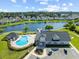 Community pool and recreation area overlooking a lake with a pier at 468 Papyrus Circle # 468, Little River, SC 29566