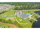 Aerial shot of a community pool, tennis courts, and clubhouse with lake access at 468 Papyrus Circle # 468, Little River, SC 29566
