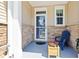 Charming front porch with stone accents, blue chair, and a welcoming floral arrangement at 468 Papyrus Circle # 468, Little River, SC 29566