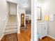 Hallway view with staircase, grandfather clock, powder room and hardwood floors at 468 Papyrus Circle # 468, Little River, SC 29566