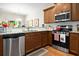 This kitchen boasts stainless steel appliances, granite countertops, wooden cabinets and tile backsplash at 468 Papyrus Circle # 468, Little River, SC 29566