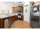 Well-lit kitchen with stainless steel appliances, wooden cabinets, granite countertops, and hardwood floors at 468 Papyrus Circle # 468, Little River, SC 29566