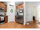 Cozy kitchen with wooden floors, stainless steel refrigerator, white cabinets, and decorative wreath at 468 Papyrus Circle # 468, Little River, SC 29566