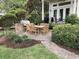 Beautiful backyard with a brick patio, outdoor dining area, grill, and lush landscaping at 4744 Bucks Bluff Dr., North Myrtle Beach, SC 29582