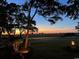 Expansive backyard view with mature trees and a stunning sunset over the golf course at 4744 Bucks Bluff Dr., North Myrtle Beach, SC 29582