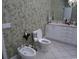 Bathroom with a bidet, toilet and nice sink with counter and cabinets at 4744 Bucks Bluff Dr., North Myrtle Beach, SC 29582