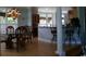 Open-concept dining area with a glass table, wooden chairs, and breakfast bar in the background at 4744 Bucks Bluff Dr., North Myrtle Beach, SC 29582