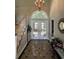Inviting foyer with a chandelier, tiled floor, staircase, and double doors leading to the outside at 4744 Bucks Bluff Dr., North Myrtle Beach, SC 29582