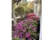 Beautifully landscaped with vibrant pink flowers and lush greenery along the side of the home at 4744 Bucks Bluff Dr., North Myrtle Beach, SC 29582