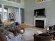 Bright living room with a fireplace, large TV, and comfortable seating area with a patterned sofa at 4744 Bucks Bluff Dr., North Myrtle Beach, SC 29582