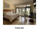Comfortable main bedroom with hardwood floors, bright windows, and a ceiling fan at 4744 Bucks Bluff Dr., North Myrtle Beach, SC 29582