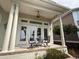Covered patio with white columns and ample seating space, great for outdoor entertaining at 4744 Bucks Bluff Dr., North Myrtle Beach, SC 29582
