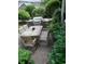 Outdoor patio with a wooden table and chairs, surrounded by lush greenery and flowers at 4744 Bucks Bluff Dr., North Myrtle Beach, SC 29582
