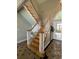Elegant staircase with white railings and wooden steps leading to the upper level of the home at 4744 Bucks Bluff Dr., North Myrtle Beach, SC 29582