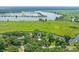 An aerial view of a secluded riverfront home enveloped by lush trees and green fields at 485 Waterford Dr., Georgetown, SC 29440