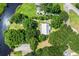 An aerial view showing the home's setting amongst mature trees and lush landscaping at 485 Waterford Dr., Georgetown, SC 29440