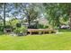 A lovely back yard featuring a beautiful garden, outdoor seating, and a view of the property and boat at 485 Waterford Dr., Georgetown, SC 29440