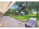 Expansive backyard with a large deck, lush greenery, an outbuilding, and an outdoor grill at 485 Waterford Dr., Georgetown, SC 29440