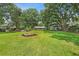 Landscaped backyard with fire pit, shed, and screened-in porch, perfect for outdoor living at 485 Waterford Dr., Georgetown, SC 29440