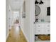 Hallway leading into a full bathroom with a white vanity and black fixtures at 485 Waterford Dr., Georgetown, SC 29440