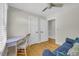 Well-lit bedroom with a desk, hardwood floors, and neutral paint at 485 Waterford Dr., Georgetown, SC 29440