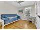Bright bedroom with hardwood floors, a blue futon, and a window view at 485 Waterford Dr., Georgetown, SC 29440