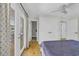 Bright bedroom features hardwood floors, ceiling fan, ensuite bathroom, and access to sunroom through glass doors at 485 Waterford Dr., Georgetown, SC 29440