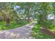 Picturesque home with mature trees, long gravel driveway, and well-manicured lawn at 485 Waterford Dr., Georgetown, SC 29440