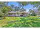 Charming single-story home with a lush green lawn, inviting front porch, and a patriotic American flag at 485 Waterford Dr., Georgetown, SC 29440