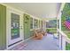 Cozy front porch featuring rocking chairs, a welcome mat, and views of the manicured lawn at 485 Waterford Dr., Georgetown, SC 29440
