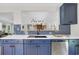 Open kitchen with blue cabinets, stainless steel appliances, and a view into the living area at 485 Waterford Dr., Georgetown, SC 29440