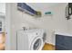 Functional laundry room with washer, dryer, storage cabinet, and overhead shelving at 485 Waterford Dr., Georgetown, SC 29440