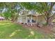 Charming outbuilding nestled amongst mature trees with its own covered porch and outdoor seating at 485 Waterford Dr., Georgetown, SC 29440