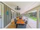 Spacious screened-in porch with outdoor dining furniture and ceiling fan, perfect for entertaining at 485 Waterford Dr., Georgetown, SC 29440