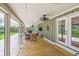 Inviting screened-in porch with wood floors, ceiling fan, and comfortable seating area at 485 Waterford Dr., Georgetown, SC 29440