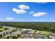 Aerial view of the building complex; golf course on one side and partial ocean view at 4872 Dahlia Ct. # 305, Myrtle Beach, SC 29577