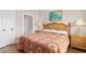 Bedroom shows private bathroom, night stands with lamps, and an accent painting at 4872 Dahlia Ct. # 305, Myrtle Beach, SC 29577