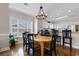 Dining area with wood table, chandelier, and breakfast bar overlooking the kitchen at 4872 Dahlia Ct. # 305, Myrtle Beach, SC 29577